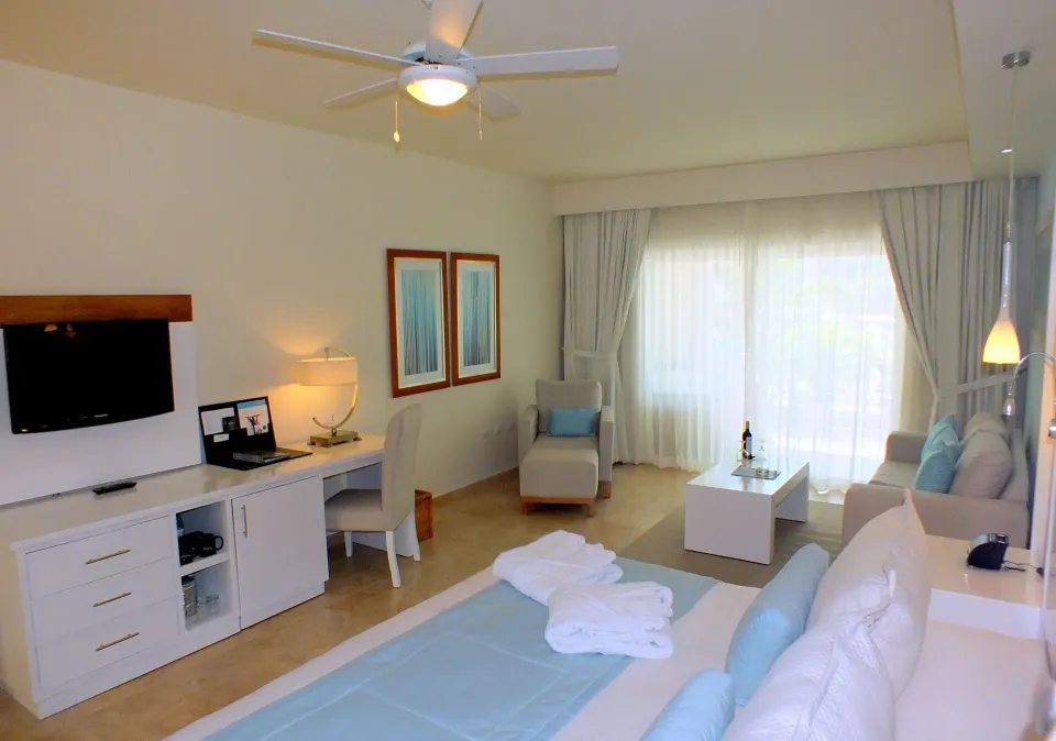 Privilege Honeymoon Junior Suite with bed and sitting area at Ocean Blue & Sand Beach Resort.
