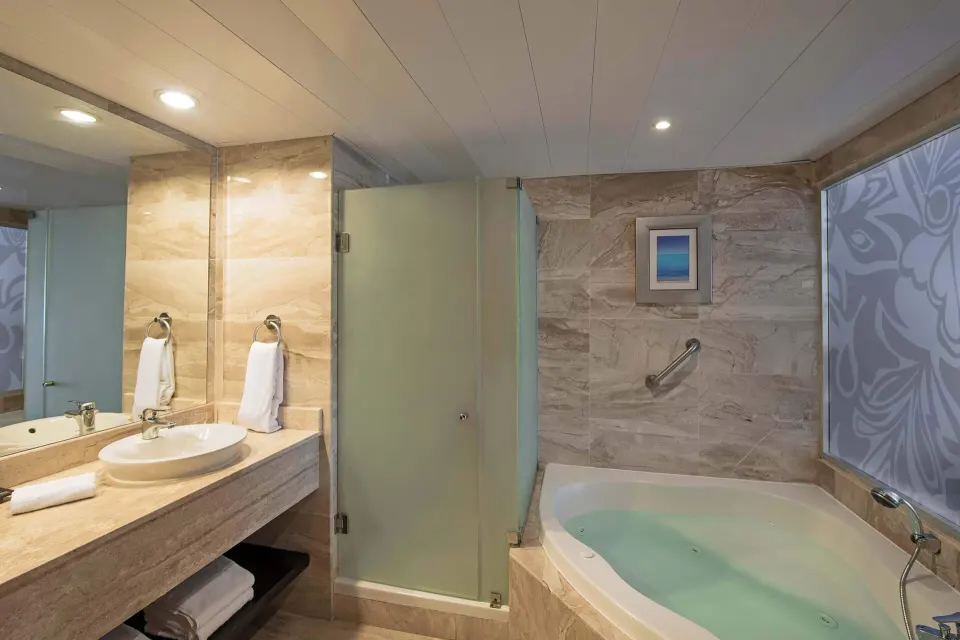 Privilege Junior Suite Nature View bathroom with tub and vanity at Ocean Blue & Sand Beach Resort.