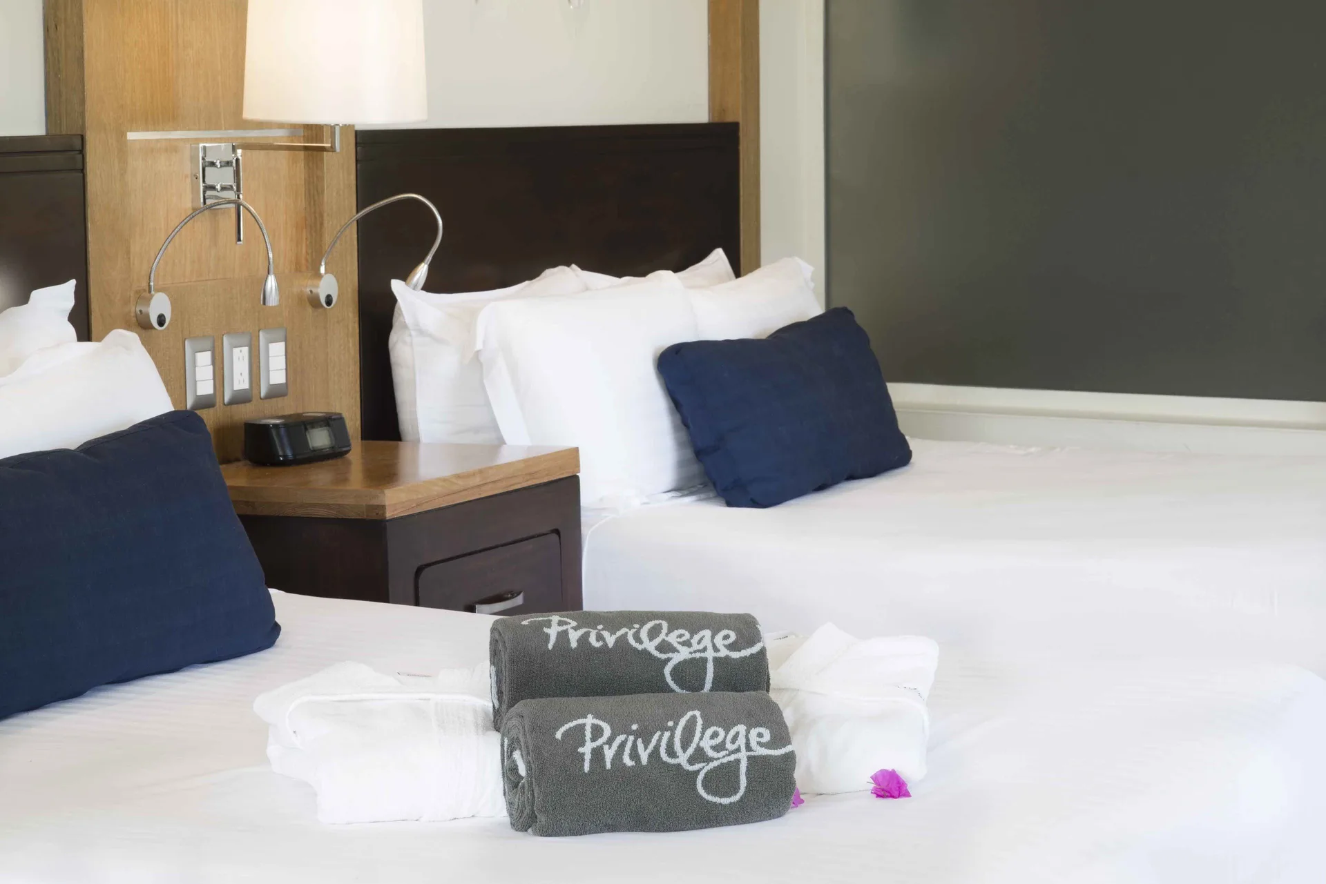 Privilege Junior Suite Nature View two beds with pillows and towels at Ocean Blue & Sand Beach Resort.