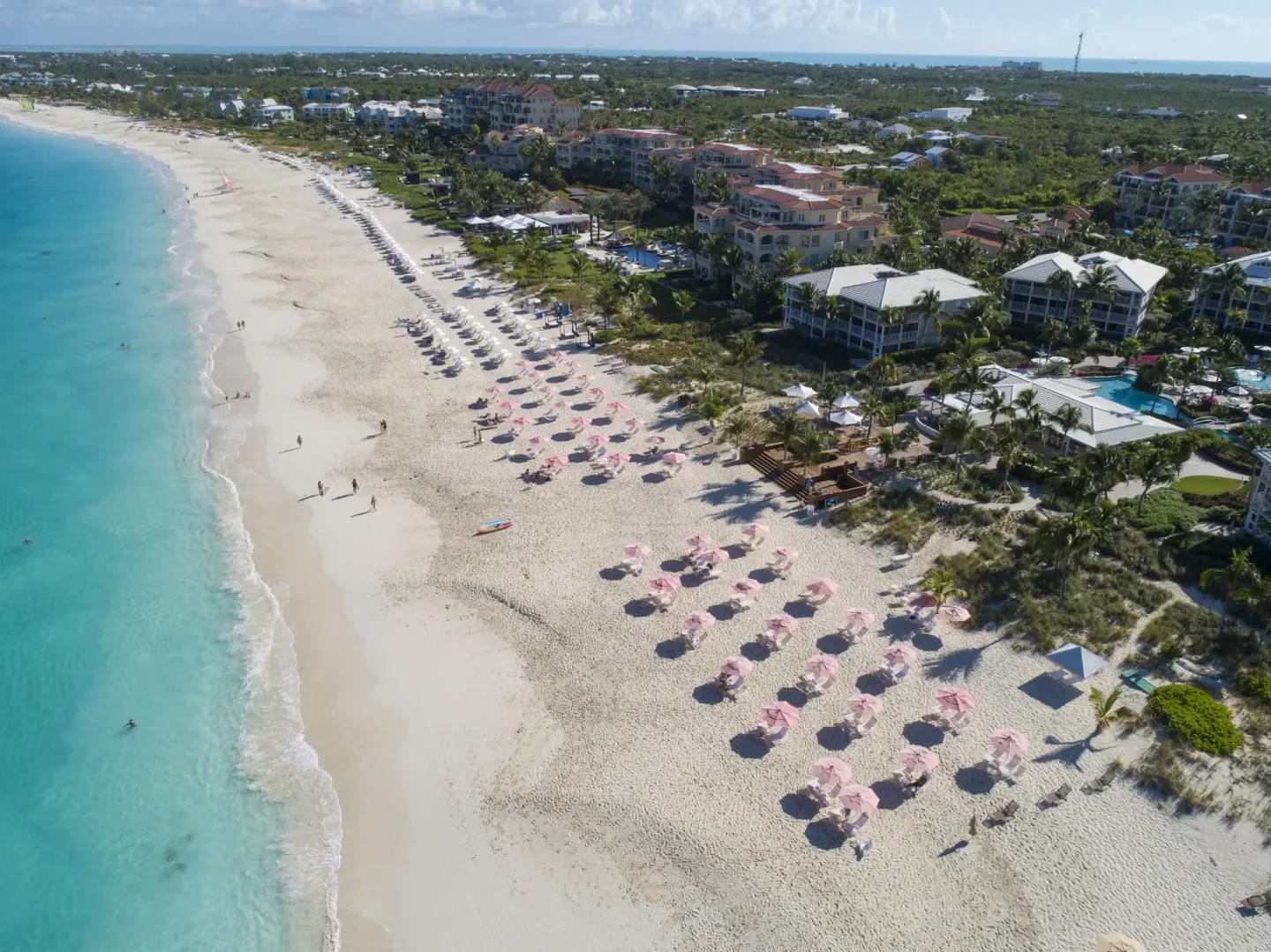 Aerial view of the beachfront and resort buildings at Ocean Club West, Grace Bay Beach.