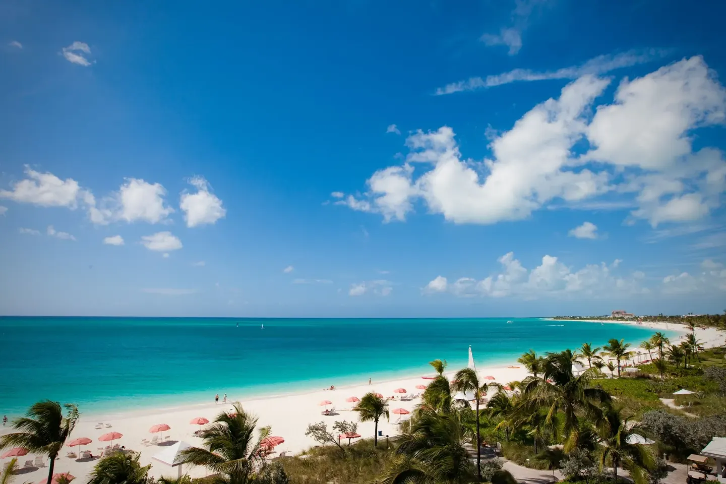 Wide view of turquoise water and white sand at Ocean Club West, Grace Bay Beach.
