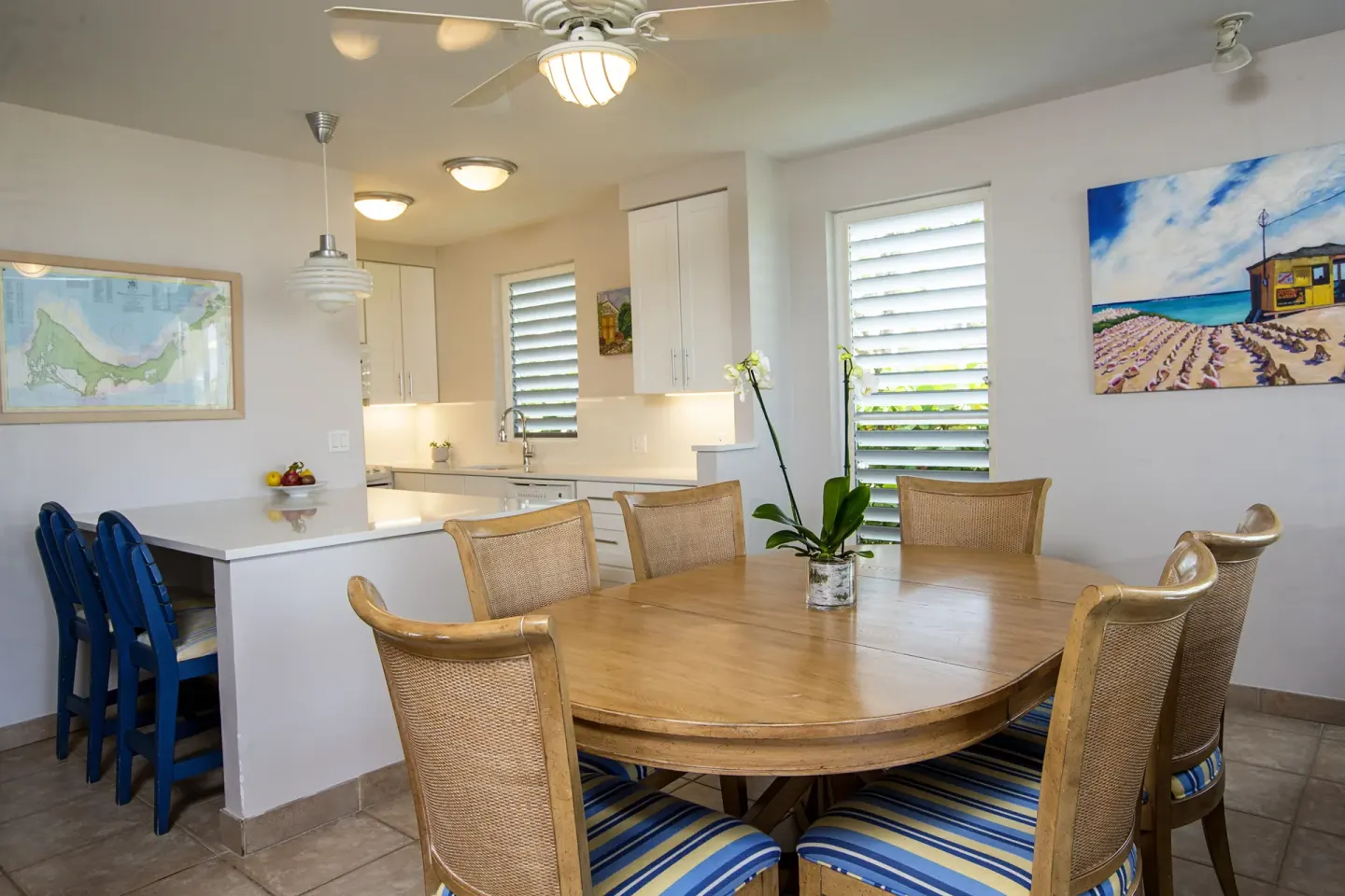 Dining table and kitchen in a beachfront deluxe suite at Ocean Club West, Grace Bay Beach.