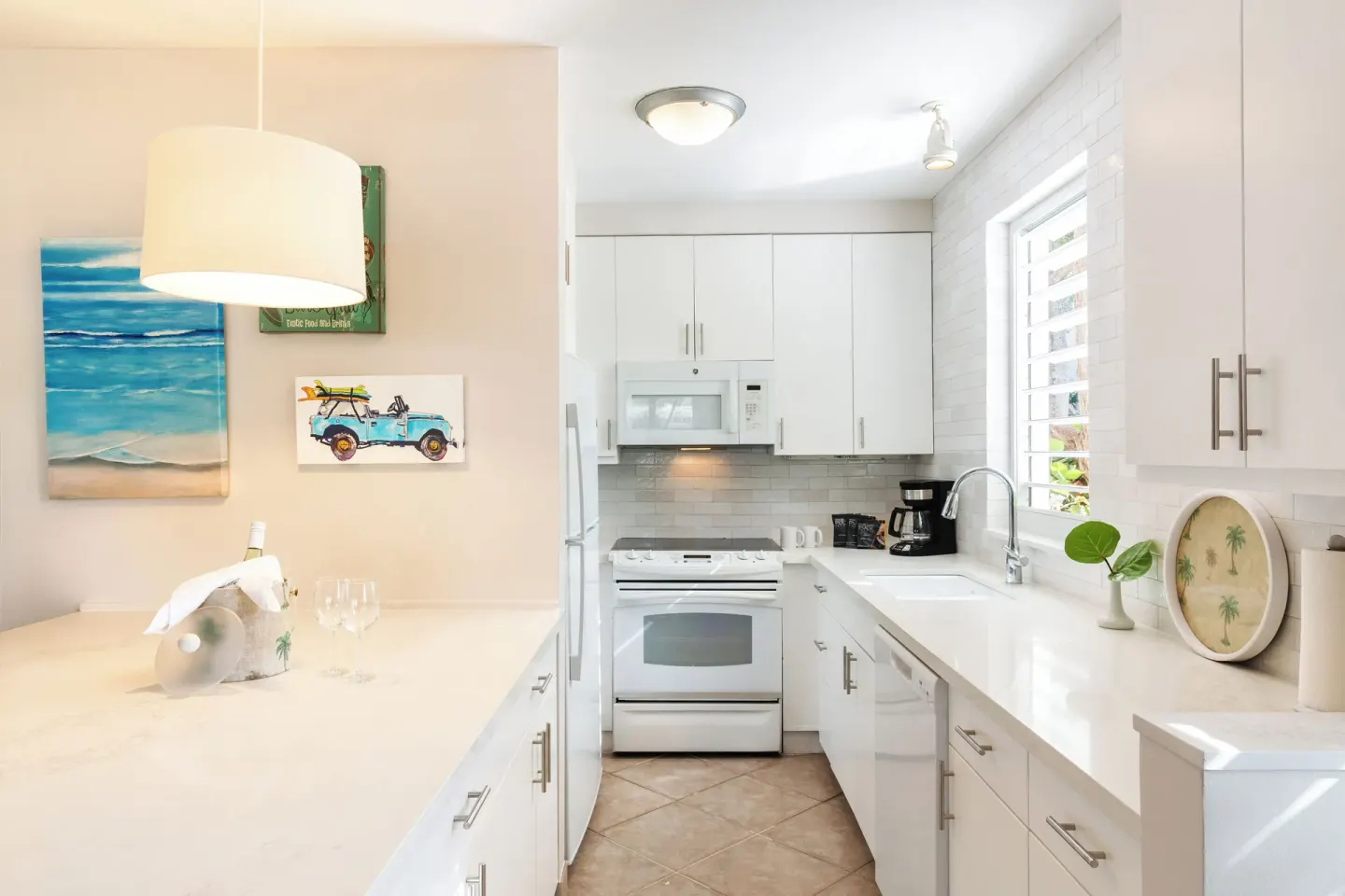 White kitchen in a Deluxe Two Bedroom Beachfront Suite at Ocean Club West, Grace Bay Beach.