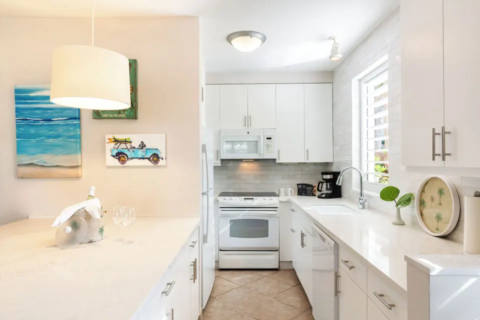 White kitchen in a Deluxe Two Bedroom Beachfront Suite at Ocean Club West, Grace Bay Beach.