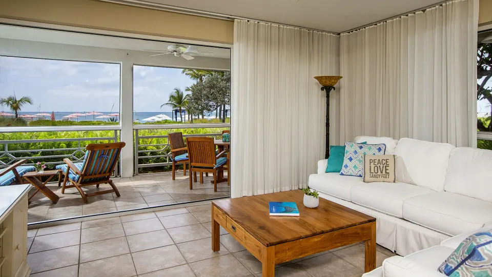Beachfront living room and patio in a Deluxe Two Bedroom Suite at Ocean Club West, Grace Bay Beach.
