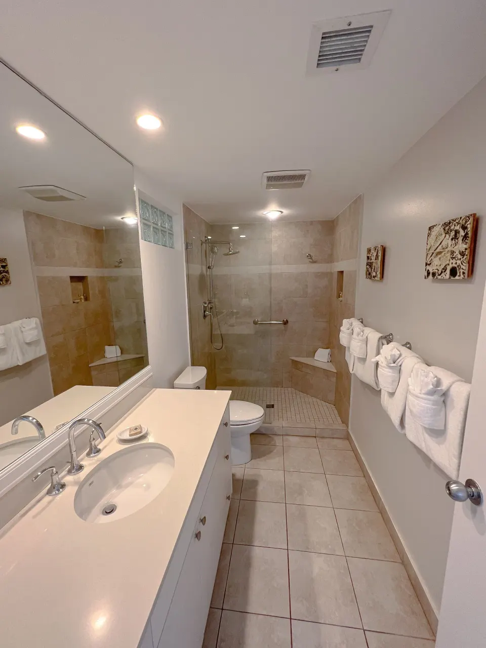 Tiled bathroom with walk-in shower in a Deluxe Two Bedroom Suite at Ocean Club West, Grace Bay Beach.