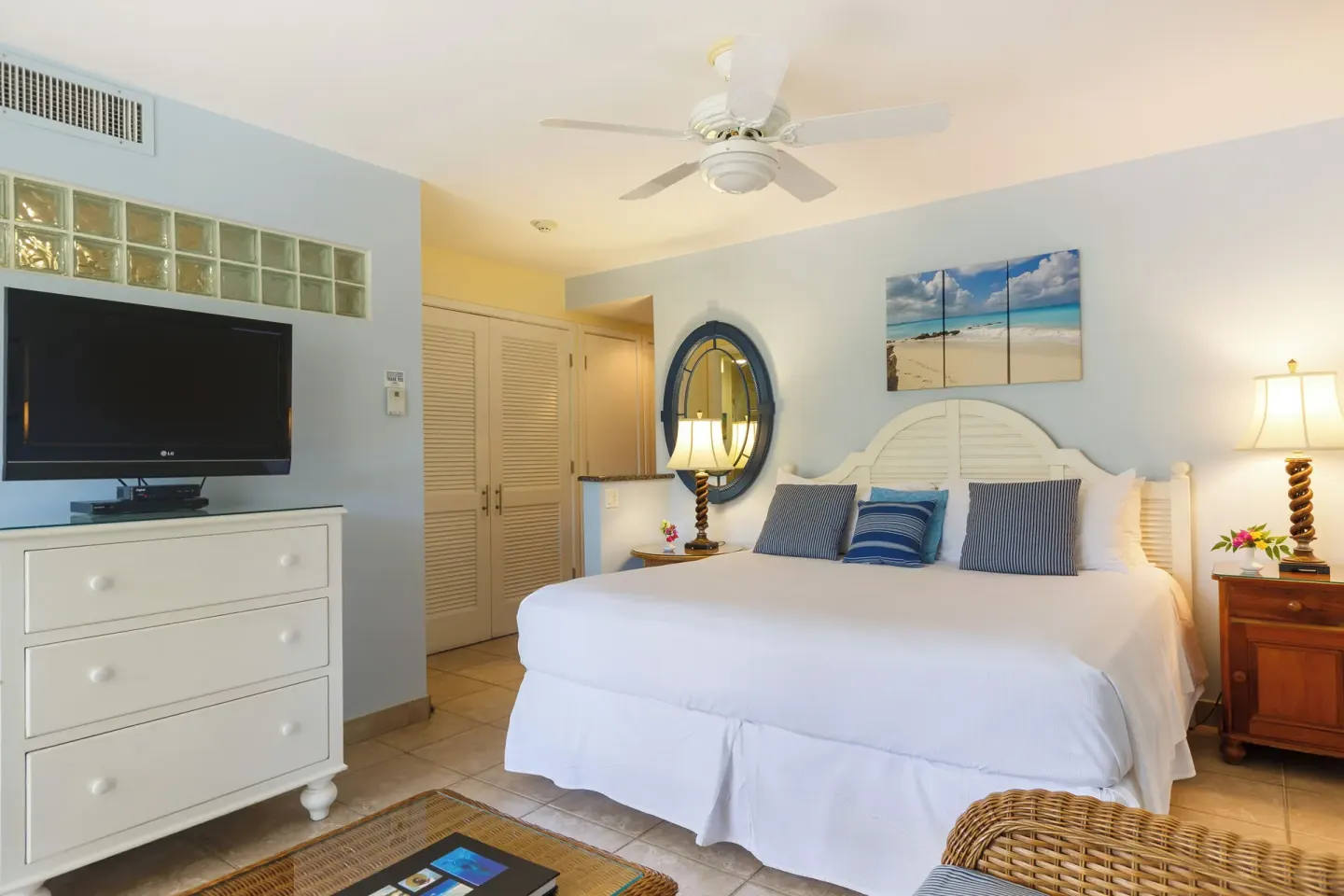 Studio suite king bed with dresser and TV at Ocean Club West, Grace Bay Beach.
