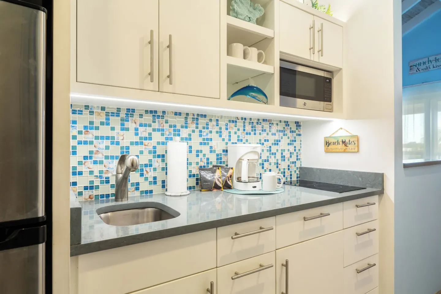 Studio suite kitchenette with blue mosaic backsplash at Ocean Club West, Grace Bay Beach.