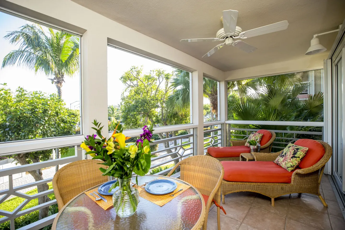 Studio suite screened balcony with dining table and chaise lounges at Ocean Club West, Grace Bay Beach.