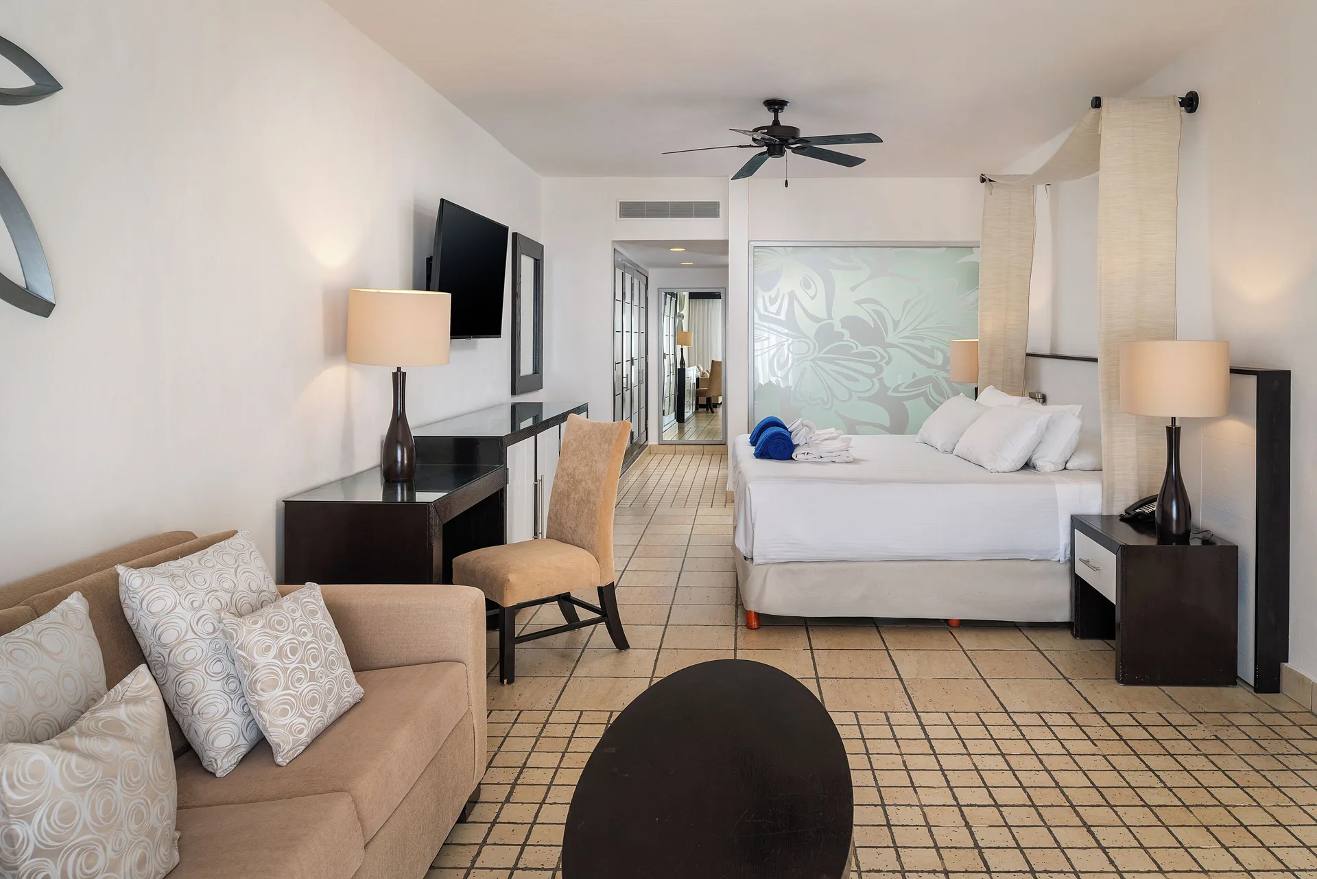 Honeymoon Suite bedroom with king bed and sofa at Ocean Coral and Turquesa.