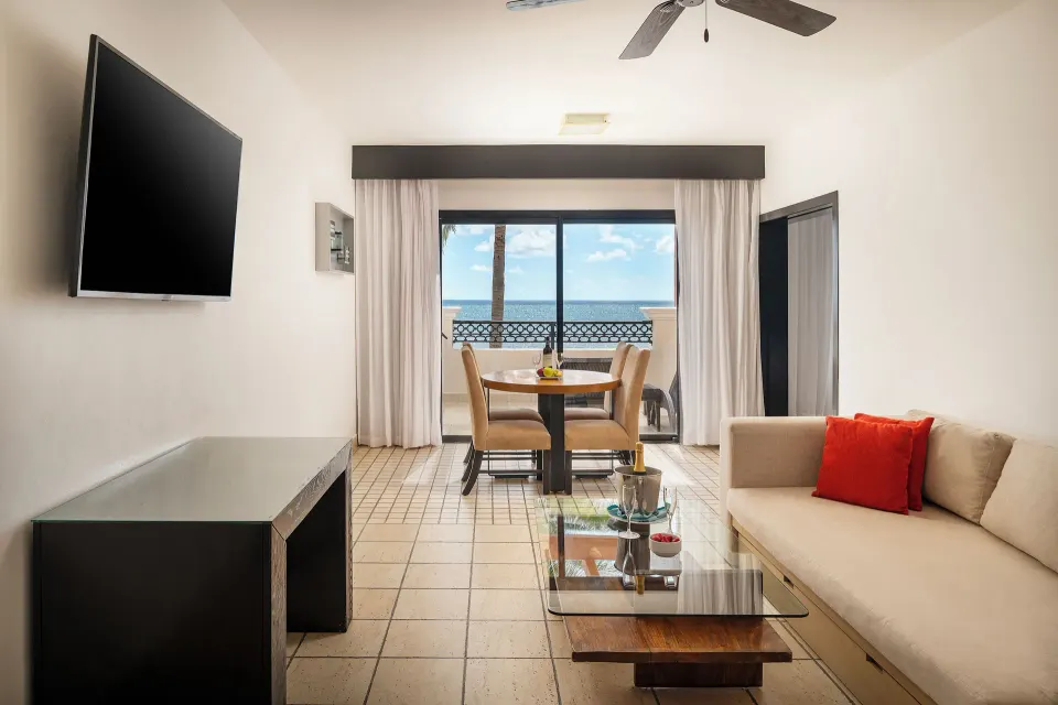 Honeymoon Suite living area with sofa and balcony view at Ocean Coral and Turquesa.