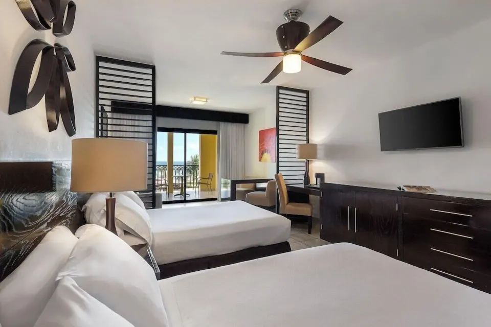 Junior Suite Waterpark Side Ocean Coral and Turquesa with two beds and balcony at Ocean Coral and Turquesa.