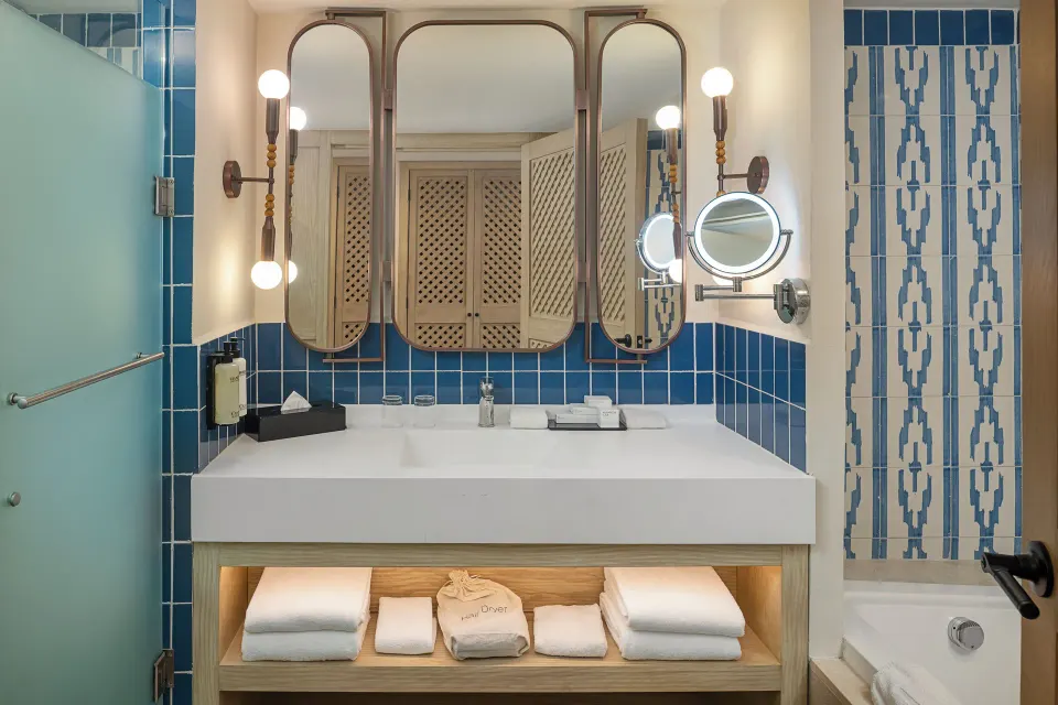 Junior Suite Waterpark Side bathroom vanity and tub at Ocean Coral and Turquesa.