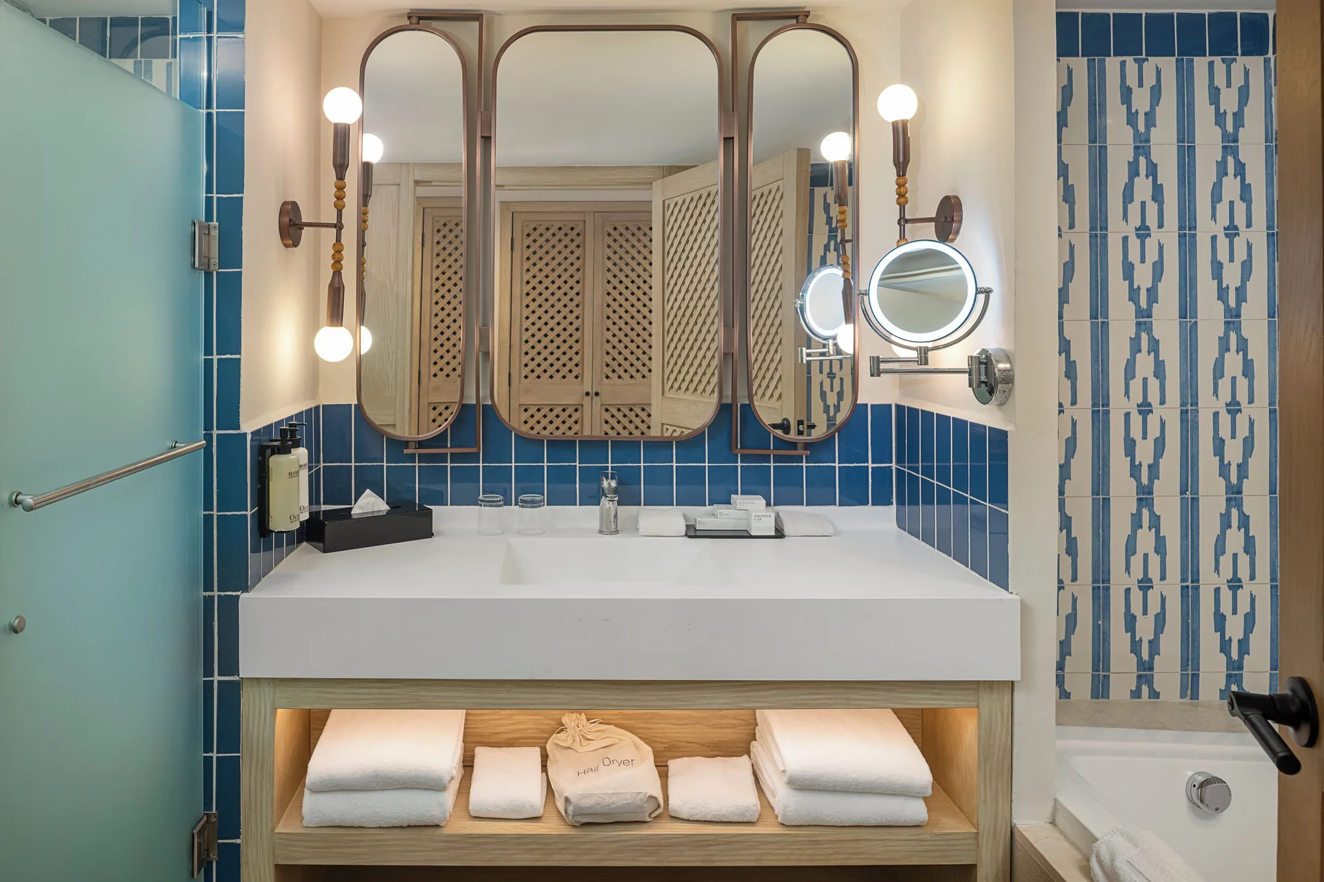 Junior Suite Waterpark Side bathroom vanity and tub at Ocean Coral and Turquesa.