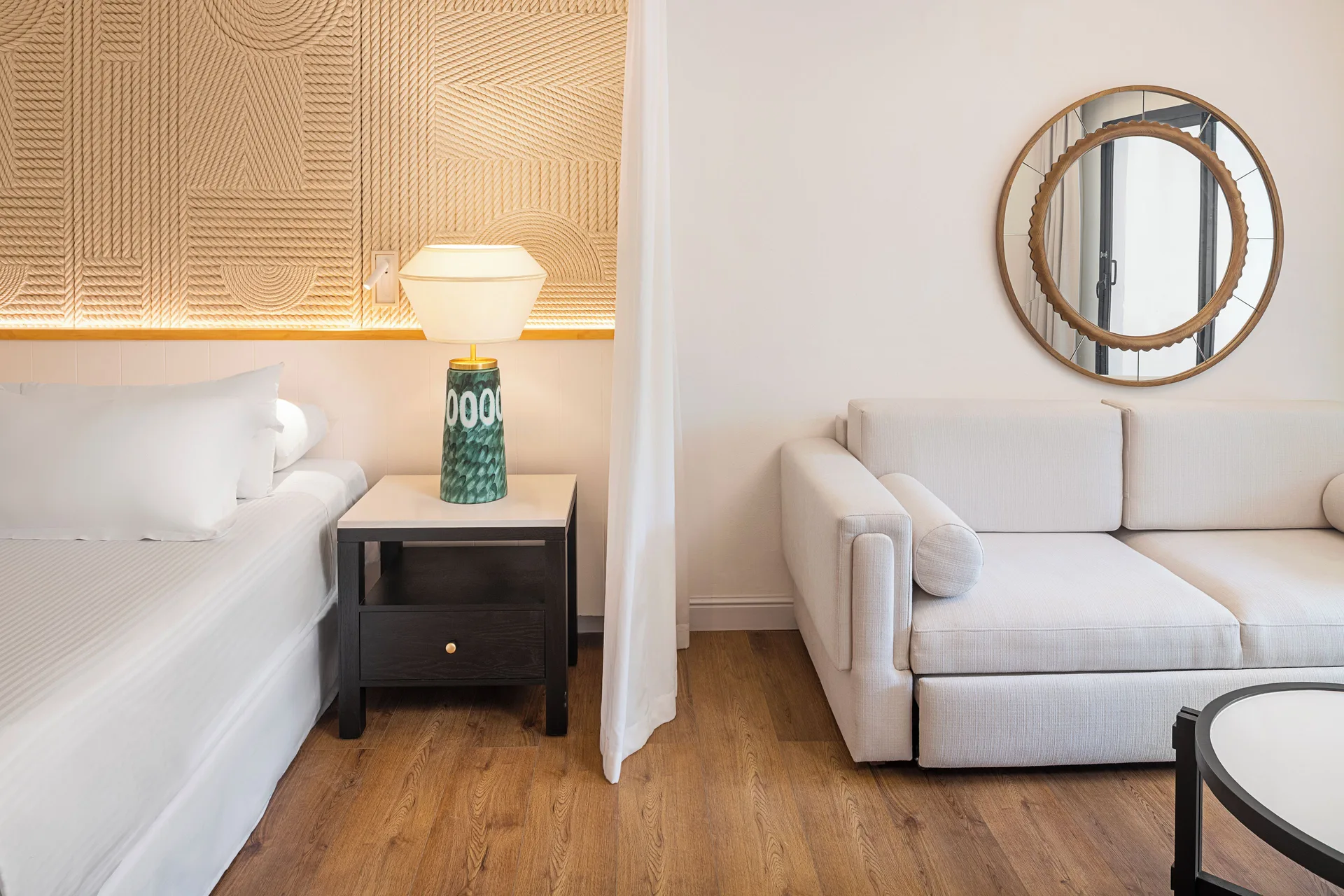 Junior Suite Waterpark Side king bed beside sofa seating at Ocean Coral and Turquesa.