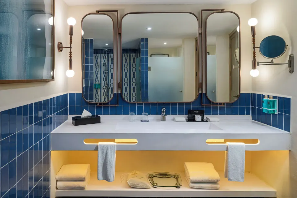 Privilege Junior Suite bathroom vanity with blue tile at Ocean Coral and Turquesa.