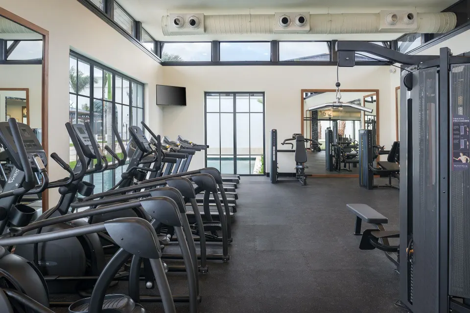 Fitness center with cardio machines and weight equipment at Ocean Coral Spring.