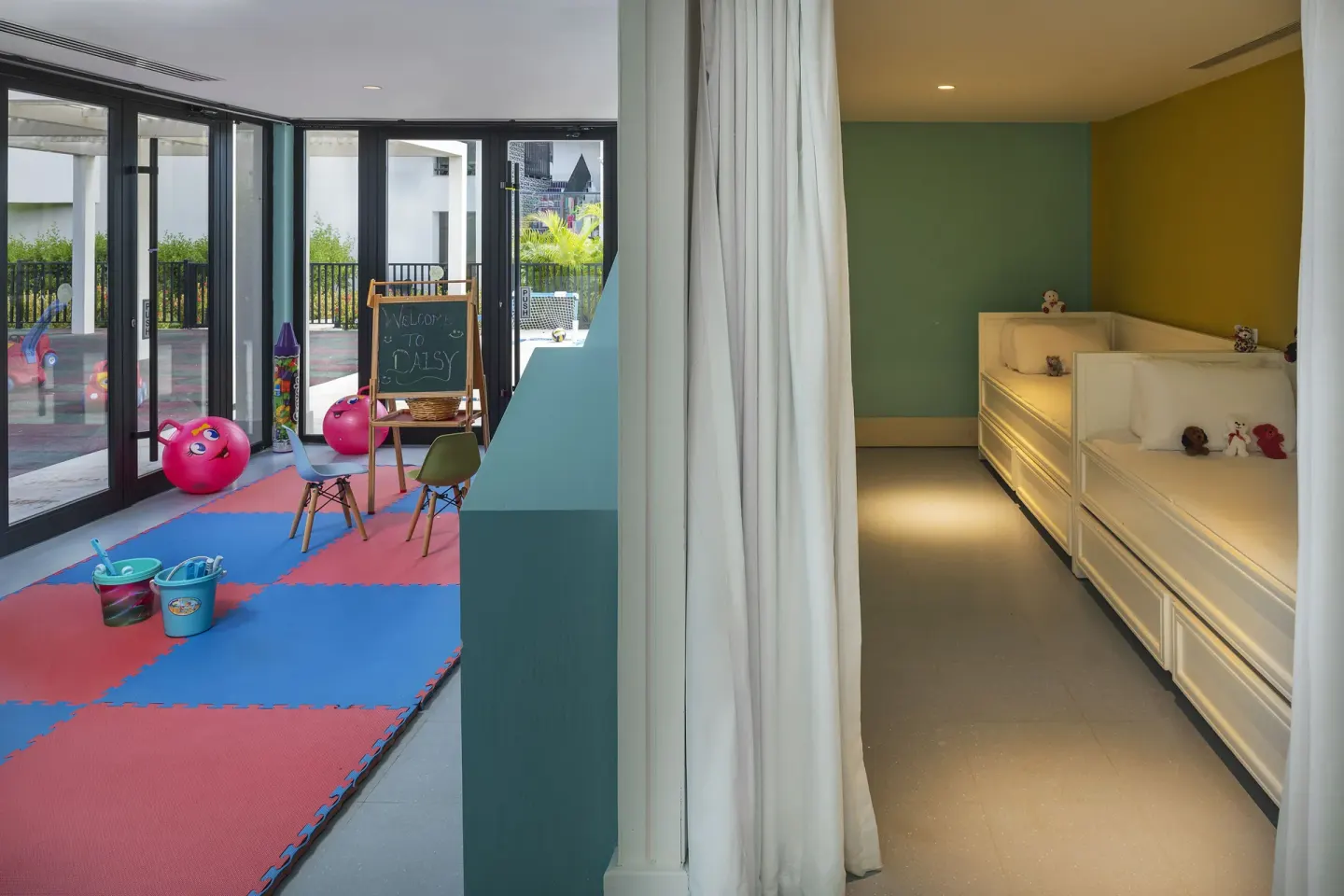 Kids' play area with foam mats and a quiet nap room at Ocean Coral Spring.