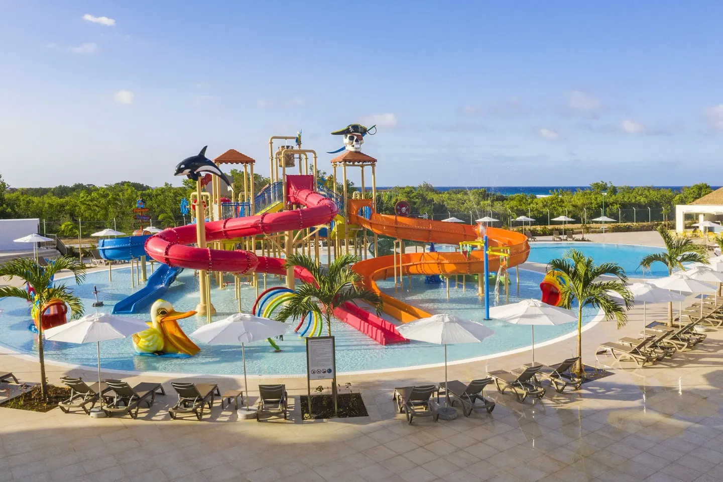 Colorful kids' water park with slides and loungers at Ocean Coral Spring.