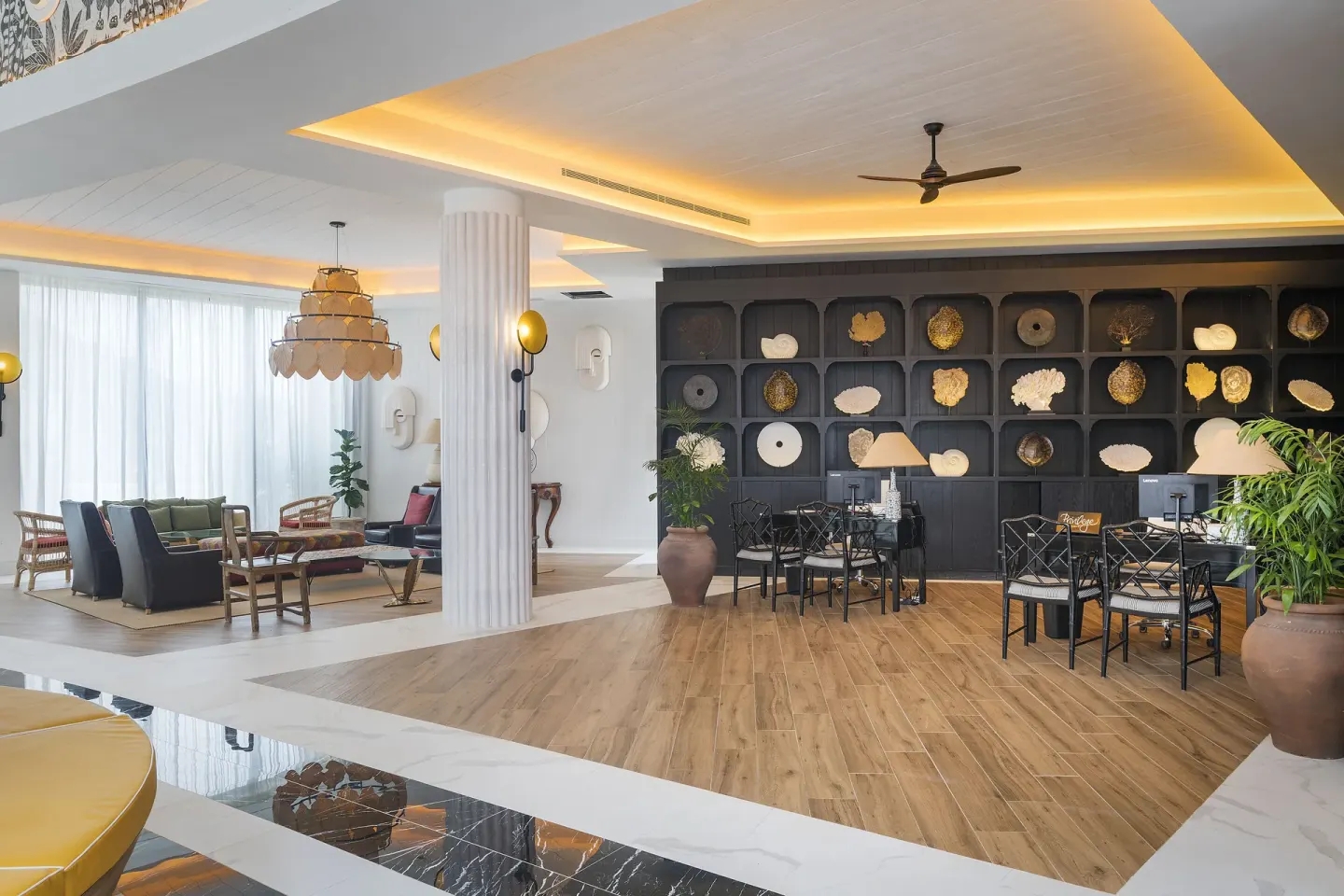 Lobby seating and reception desks with decorative wall shelves at Ocean Coral Spring.