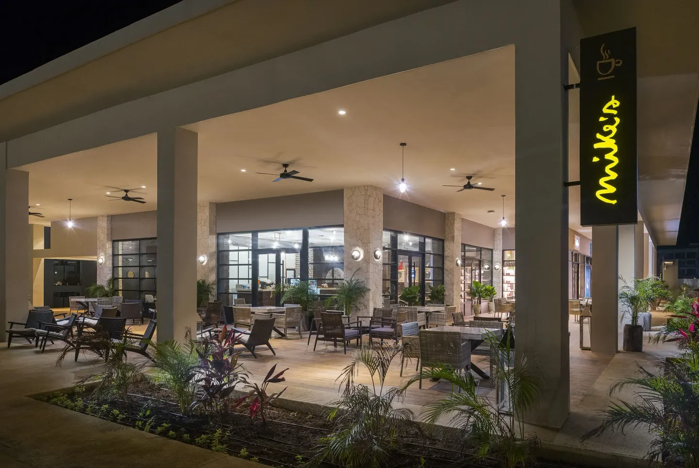 Martha's Market terrace seating and illuminated cafe sign at Ocean Coral Spring.