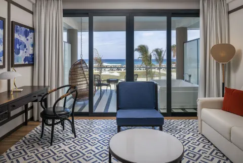 Privilege Junior Suite Nature View balcony doors and seating at Ocean Coral Spring.