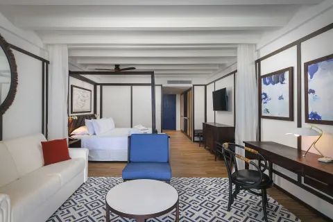 Privilege Junior Suite Nature View lounge and king bed area at Ocean Coral Spring.