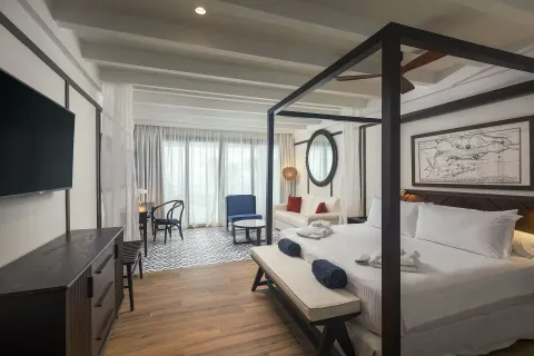Privilege Junior Suite Nature View with canopy bed and sitting area at Ocean Coral Spring.