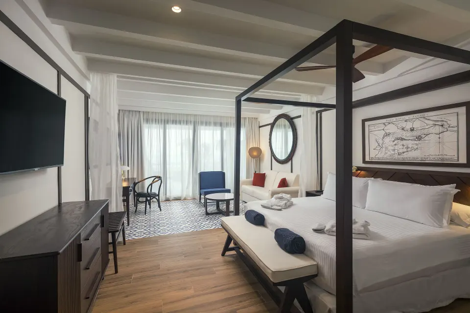 Privilege Junior Suite Nature View with canopy bed and sitting area at Ocean Coral Spring.