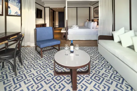 Privilege Junior Suite Nature View sitting area with bed beyond at Ocean Coral Spring.