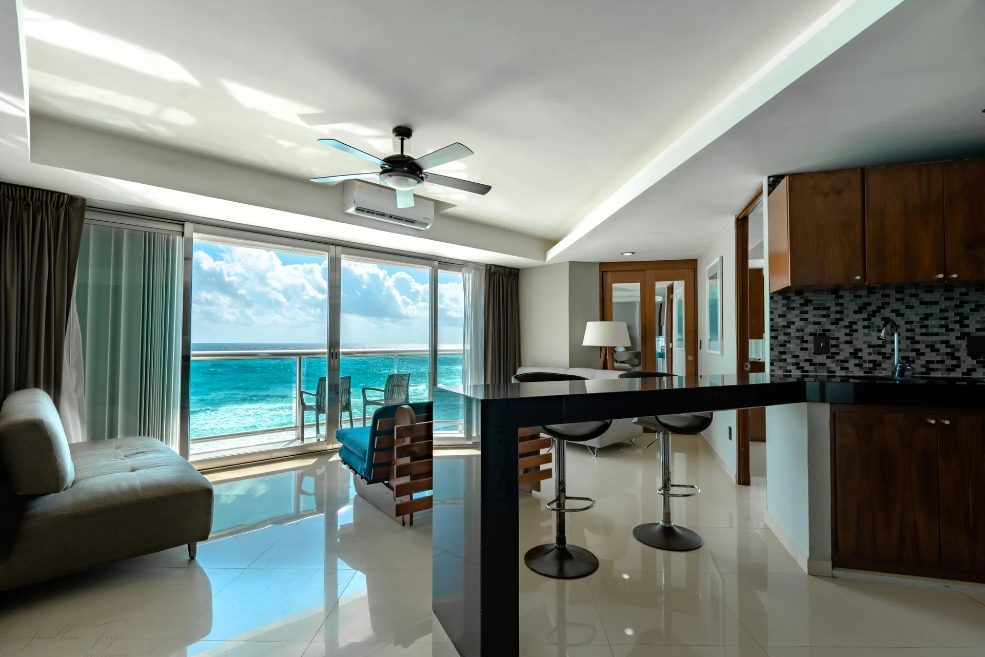 Oceanfront suite living area with kitchenette and balcony at Ocean Dream Cancun.