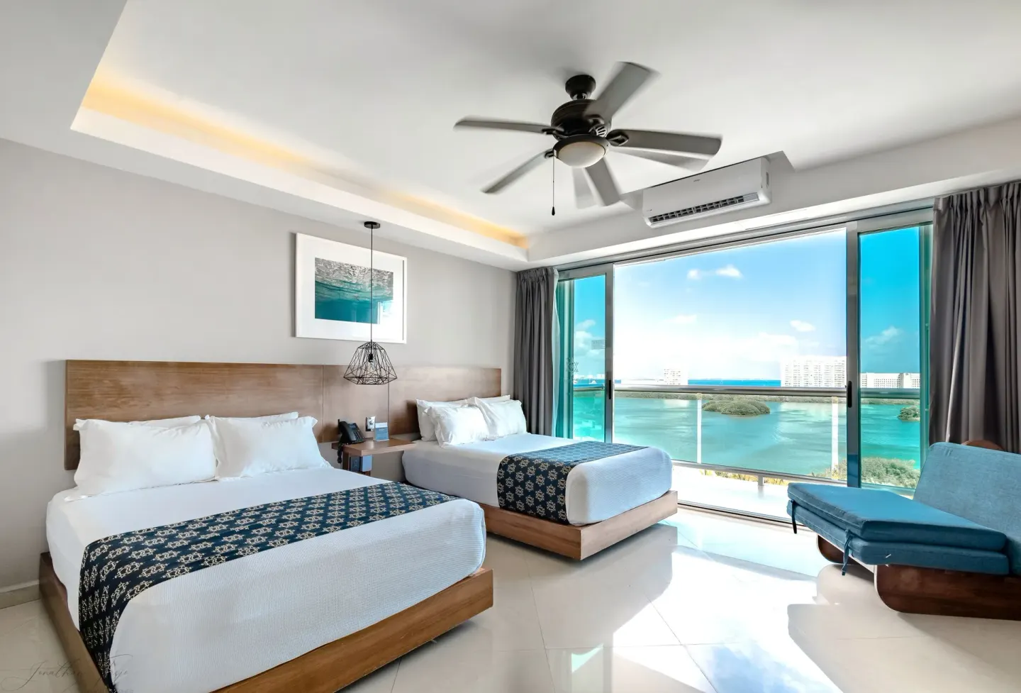 Two-bed lagoon-view guest room with chaise at Ocean Dream Cancun.