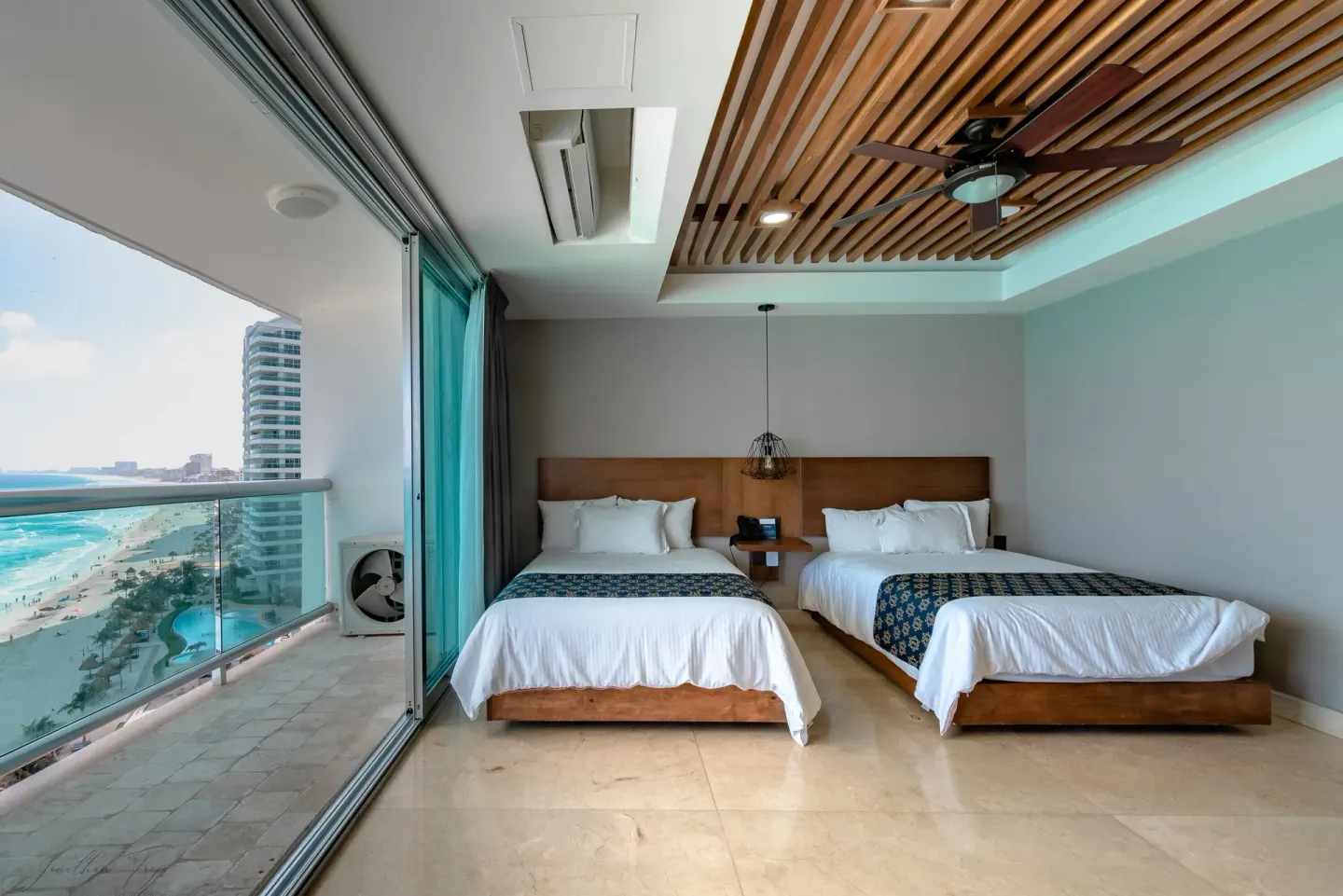Two-bed ocean-view guest room with balcony at Ocean Dream Cancun.