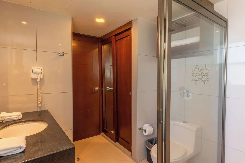 Deluxe room bathroom with glass shower and vanity at Ocean Dream Cancun.