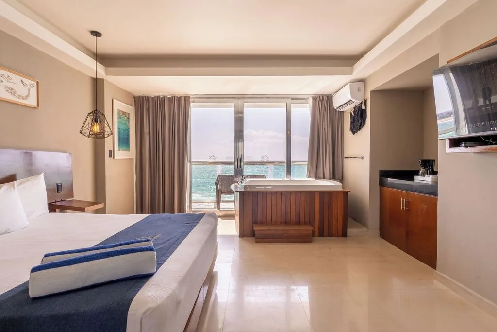 Deluxe room with king bed, indoor tub, and ocean-facing balcony at Ocean Dream Cancun.