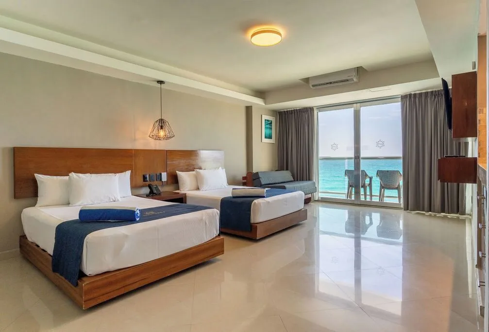 Deluxe room with two beds and oceanfront balcony at Ocean Dream Cancun.