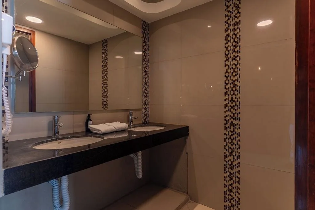Bathroom vanity with two sinks and large mirrors at Ocean Dream Cancun.