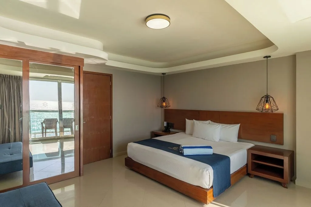 Penthouse king bedroom with mirrored closet and ocean reflection at Ocean Dream Cancun.