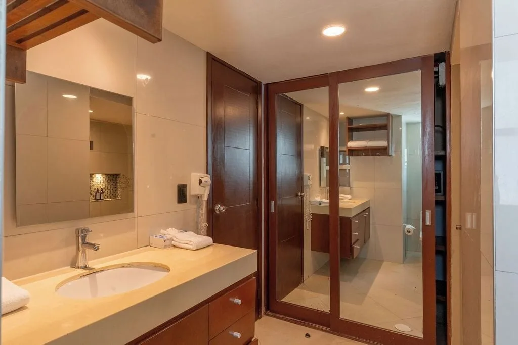 Bathroom vanity with mirrored closet doors in a Standard Room at Ocean Dream Cancun.