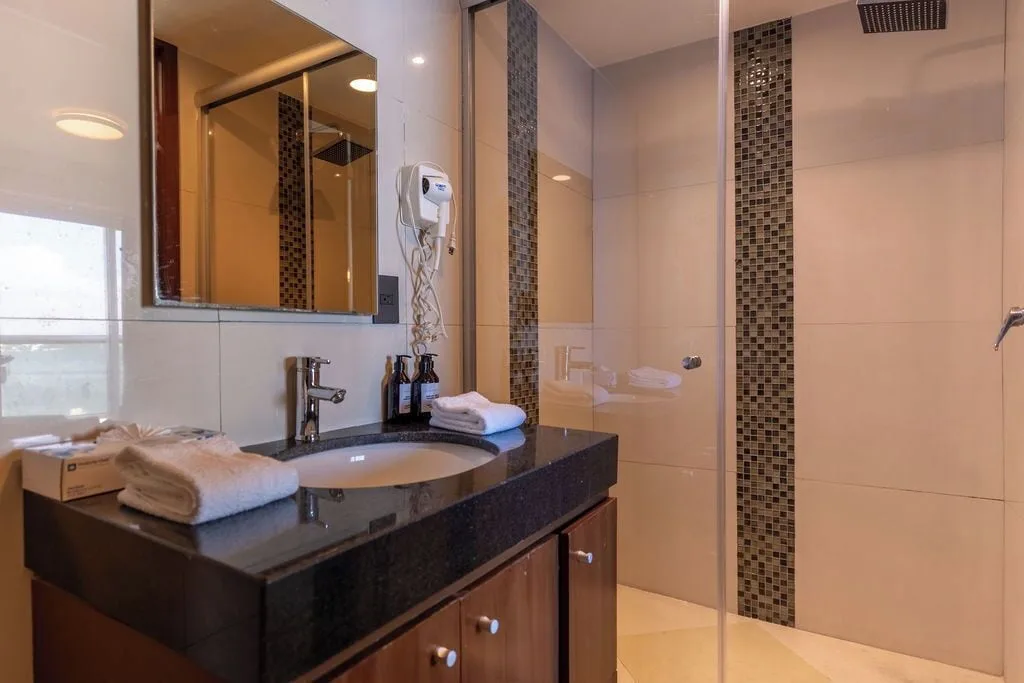 Bathroom vanity and glass shower in a Standard Room at Ocean Dream Cancun.