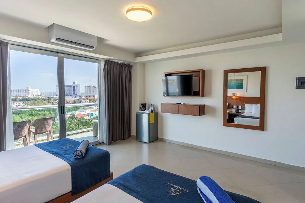 Standard Room with two double beds and balcony seating at Ocean Dream Cancun.