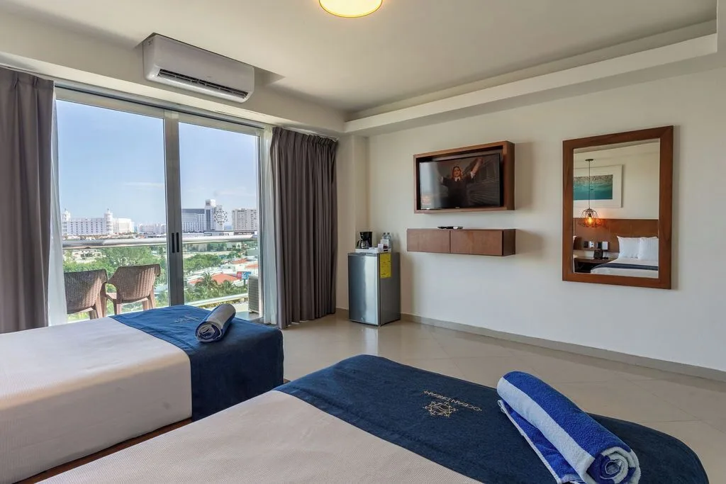 Standard Room with two double beds, TV and balcony at Ocean Dream Cancun.