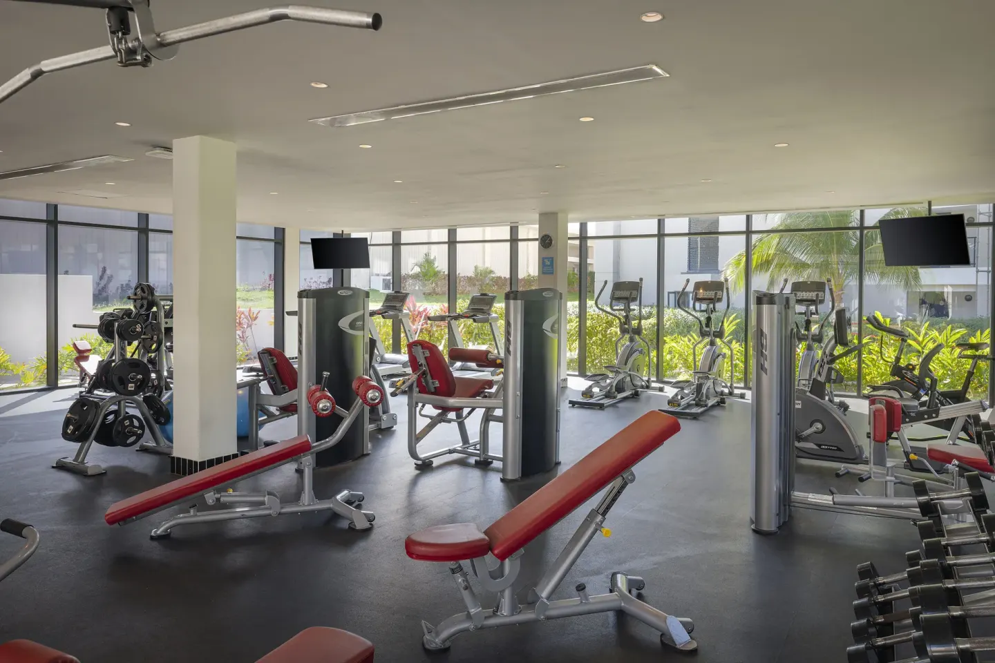 Fitness center with cardio machines, benches, and weights at Ocean Eden Bay.
