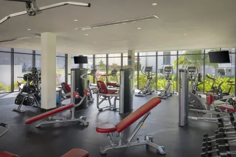 Fitness center with cardio machines, benches, and weights at Ocean Eden Bay.