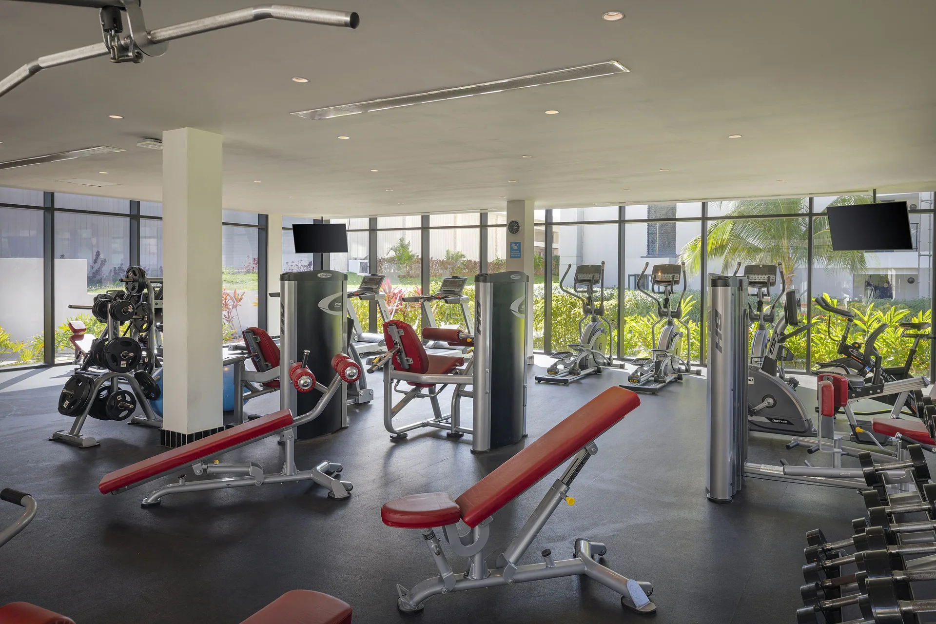 Fitness center with cardio machines, benches, and weights at Ocean Eden Bay.
