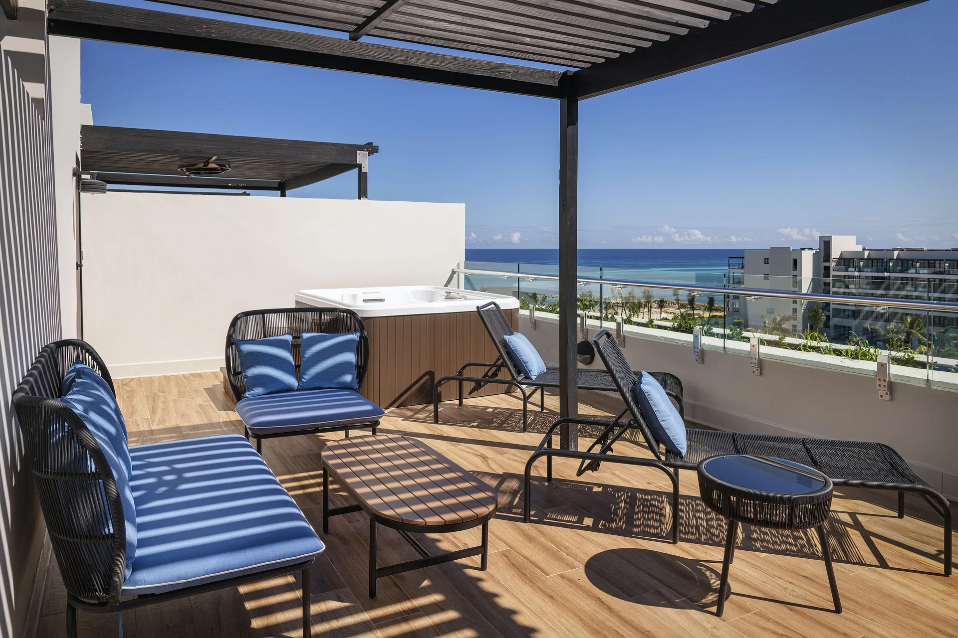 Ocean-view terrace with lounge seating and hot tub at Ocean Eden Bay.