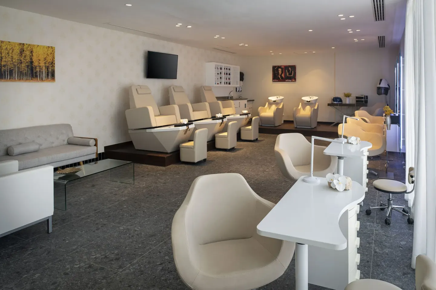 Salon room with pedicure chairs, manicure stations, and wash basins at Ocean Eden Bay.