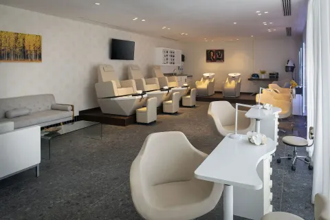 Salon room with pedicure chairs, manicure stations, and wash basins at Ocean Eden Bay.