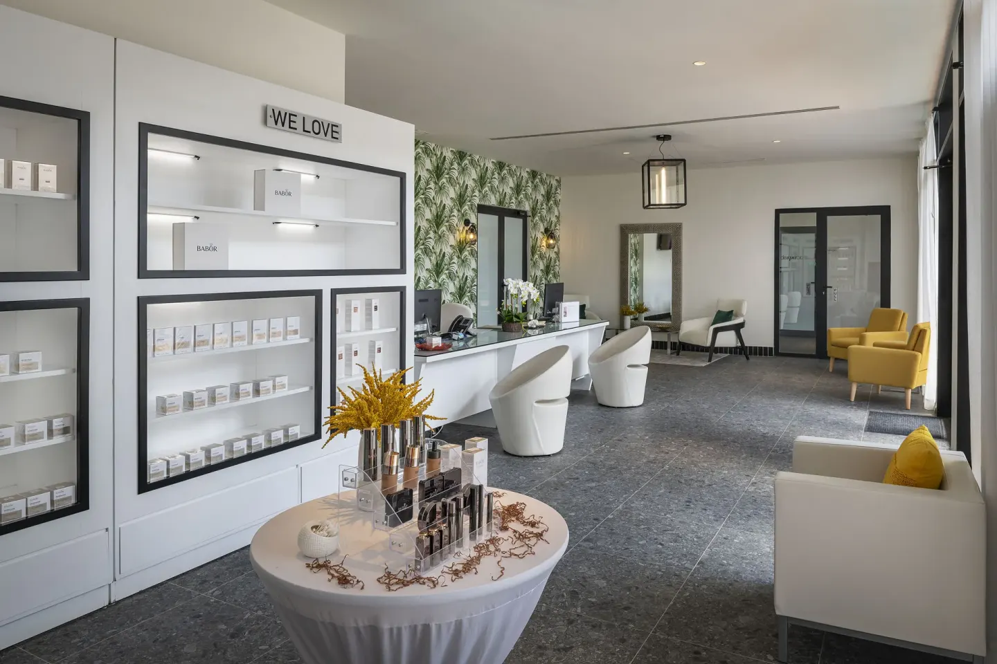 Spa reception area with product displays and lounge seating at Ocean Eden Bay.