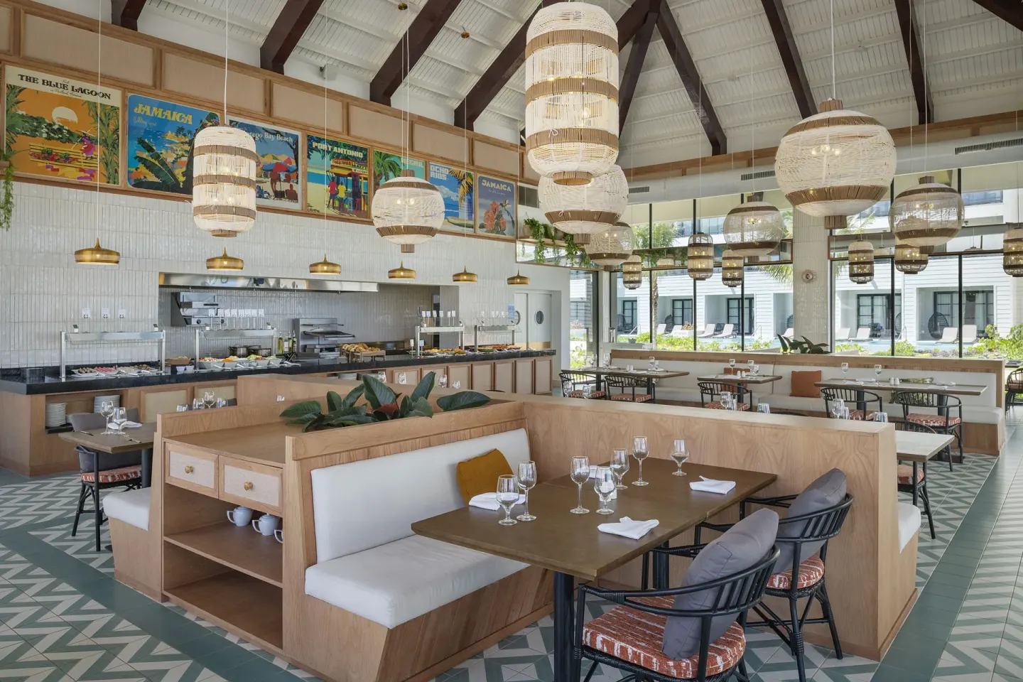 Buffet-style dining room with high ceiling and woven lamps at Ocean Eden Bay.